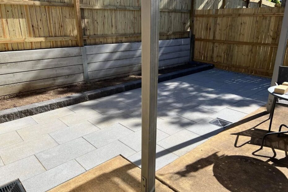 Paving extension from the concrete slab with a new garden bed, retaining wall and fences.