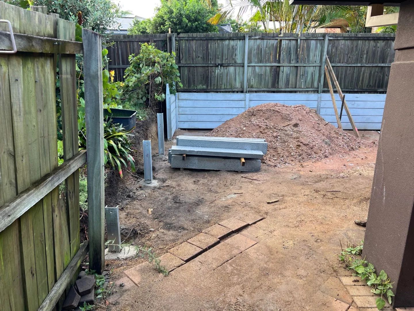 Large dig out, concrete retaining wall and colourbond fencing