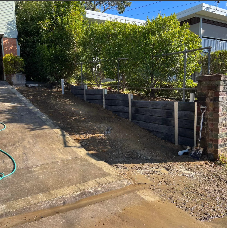 Steep driveway side retaining wall and drainage. 01