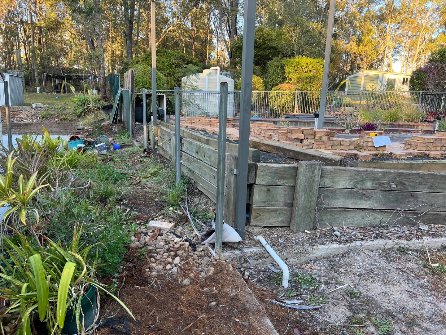 In the heart of Brisbane, a transformation was underway. Rogers Little Loaders, a renowned name in landscaping, undertook a project that would breathe new life into a residential property. The task was to replace an old timber retaining wall with a modern, durable concrete sleeper retaining wall.