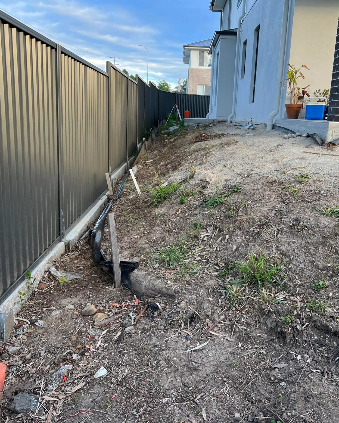 Despite the challenges, the project was a success. The once uneven and cluttered backyard was transformed into a neat, turfed area with a new boundary concrete retaining wall and colorbond fence. The result was a testament to the team’s skills and dedication.